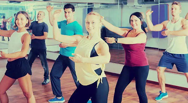 Photo of Adult people learning zumba steps