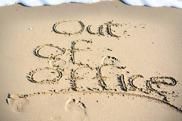 istock Out of office text written in sand on a beach 628172244