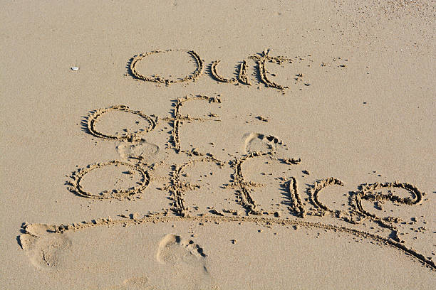 istock Out of office text written in sand on a beach 628192012