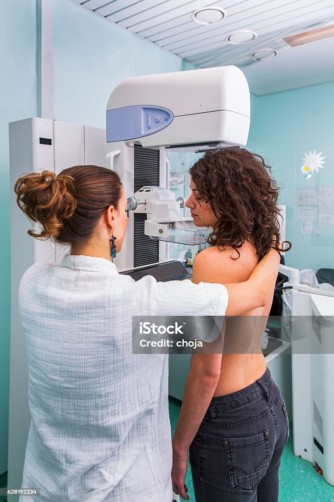 Nurse with young women having a mammography Mammogram Stock Photo