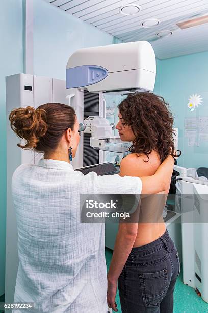 Nurse With Young Women Having A Mammography Stock Photo - Download Image Now - Mammogram, Breast Cancer, Medical Exam