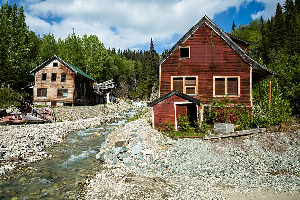 istock Two buildings standing and one collapsed by river in Alaska 628192348