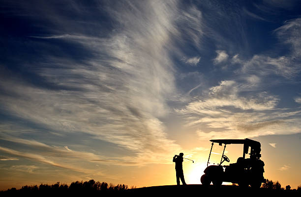 Junior Golfer Silhouette With Golf Cart A junior level golfer swinging on a golf course and enjoying the sunset. Golf cart is also in the image. Lifestyle image of unrecognizable junior golfer swinging with good form and balance. An amazing sunset sky and silhouette. Image taken with Canon 5D Mark II body and L series lens. Unrecognizable caucasian model. junior level stock pictures, royalty-free photos & images