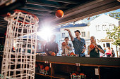Group of friends shooting hoops at the fair