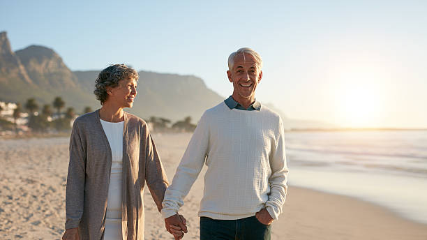 istock Senior couple enjoying a stroll on the beach 628194312