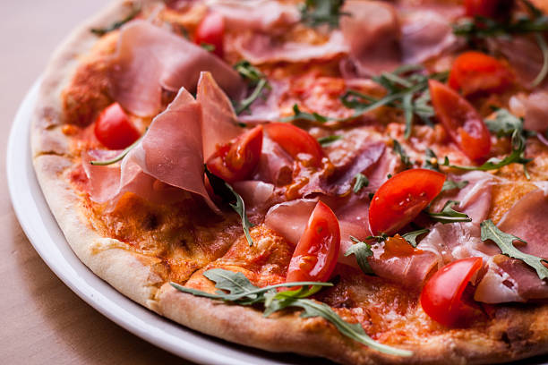 istock Pizza with Arugula, Prosciutto and Cherry Tomatoes 628196416
