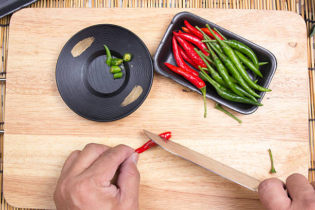 istock Hand cutting Hot Chili Peppers 628208646