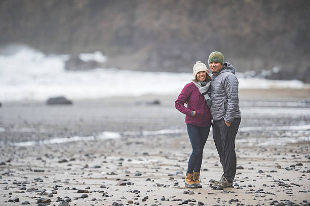 istock Ethnic couple posing while on vacation at beautiful northwest ocean 628208744