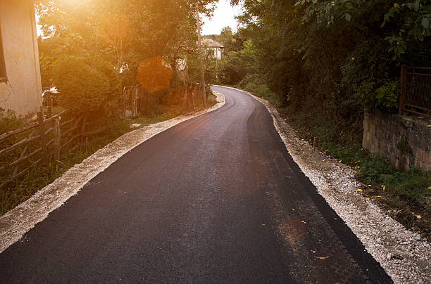 istock Winding asphalt road through mountain village at sunset. 628208932