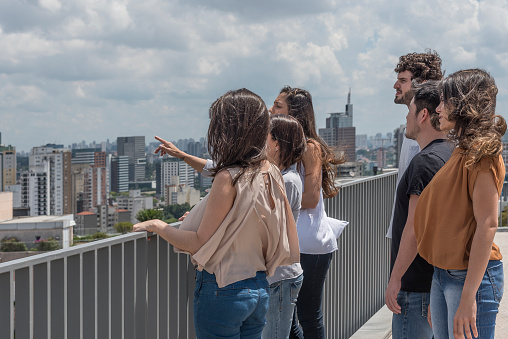 Group of young people on top of building looking ahead in São Paulo, Brazil