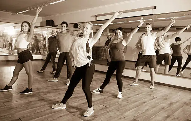 Photo of Young people learning zumba steps