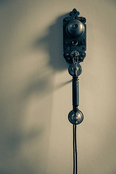 istock Old fashioned gritty image simple of telephone hanging on wall 628209500