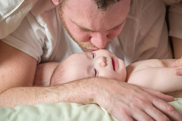 istock Mixed Race Chinese Caucasian Baby Boy Laying With Daddy 628210996