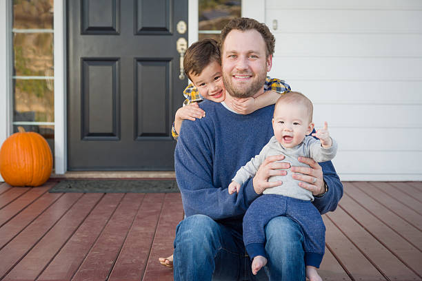 istock Mixed Race Father and His Two Sons on Front Porch 628216728