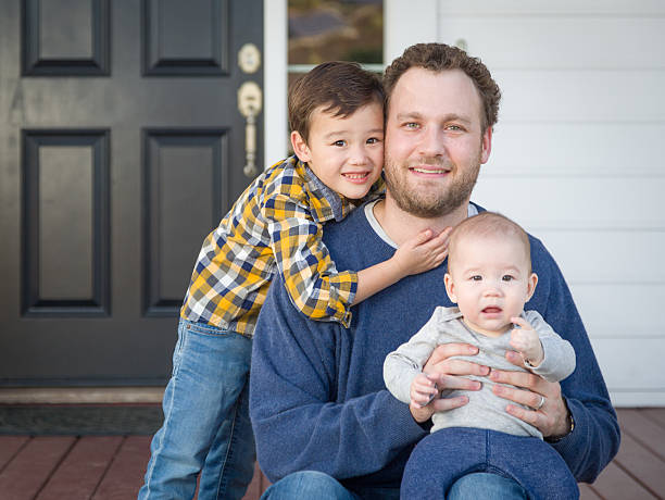istock Mixed Race Father and His Two Sons on Front Porch 628216778