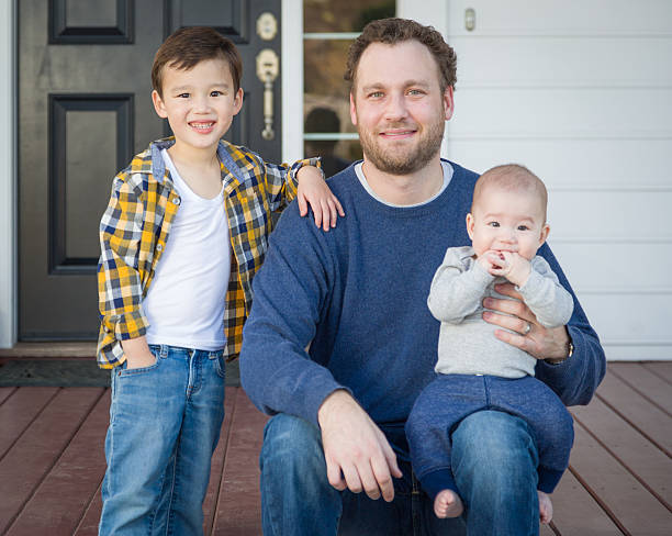 istock Mixed Race Father and His Two Sons on Front Porch 628216824