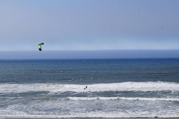 istock Kite Surfer Riding a Wave into the Pacific Ocean 628220058