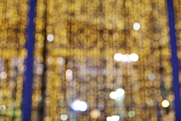 Golden glittering christmas lights. Blurred abstract background. Bokeh stock photo