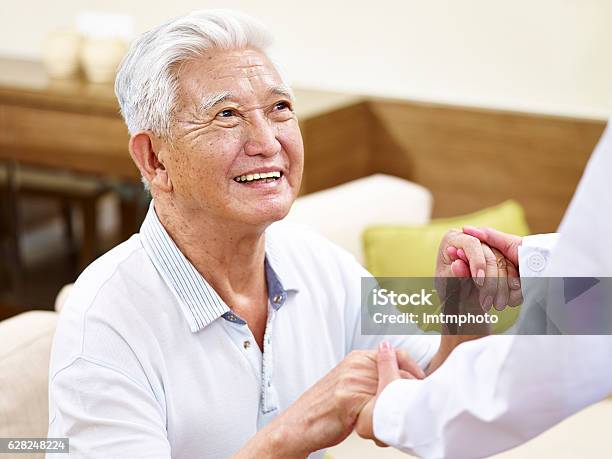Senior Asian Man Getting Helped Stock Photo - Download Image Now - Senior Adult, Nursing Home, Lifestyles