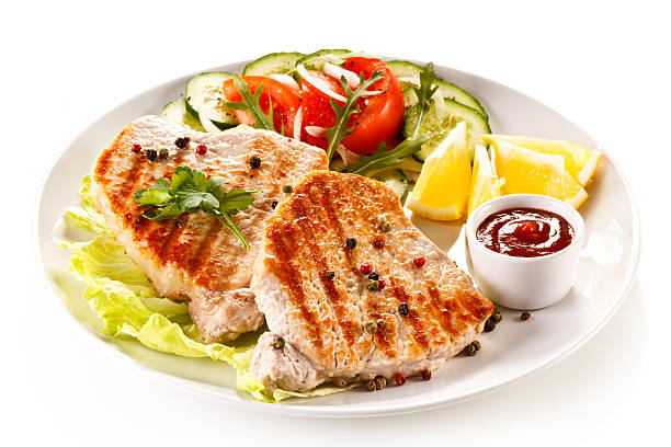 istock Grilled steaks and vegetables on white background 628250198