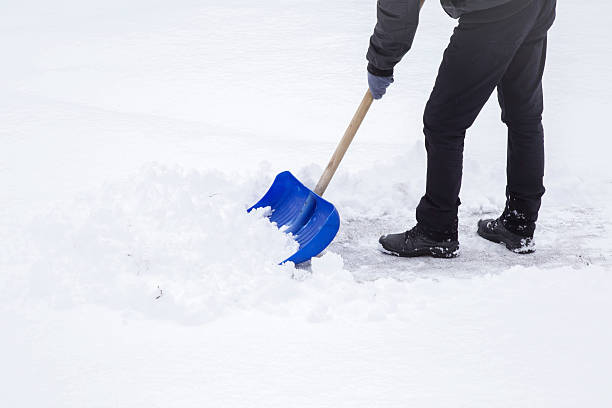 istock Man cleaning snow with shovel in winter day. 628262706