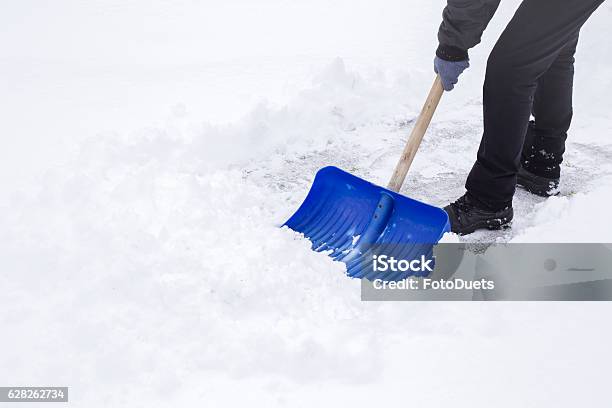 Man Cleaning Snow With Shovel In Winter Day Stock Photo - Download Image Now - Snow, Shovel, Digging