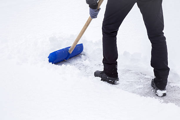 istock Man cleaning snow with shovel in winter day. 628262774