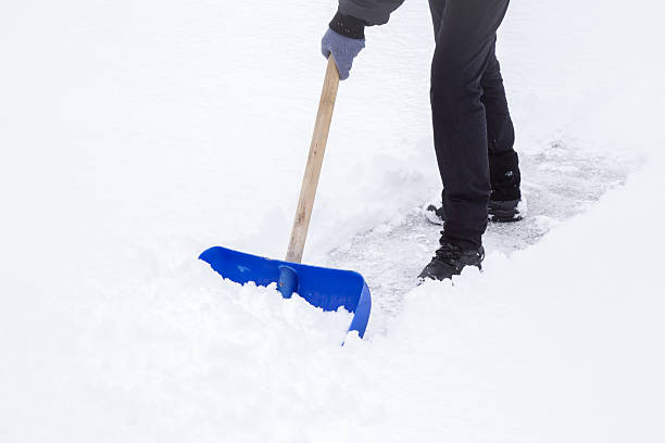 istock Man cleaning snow with shovel in winter day. 628262808