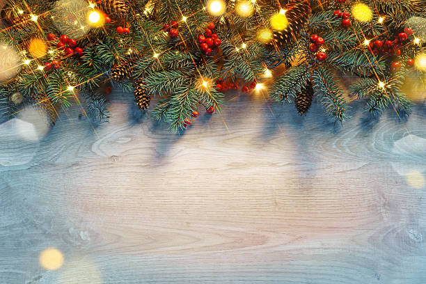 istock Christmas fir tree with lights on wooden background 628263280
