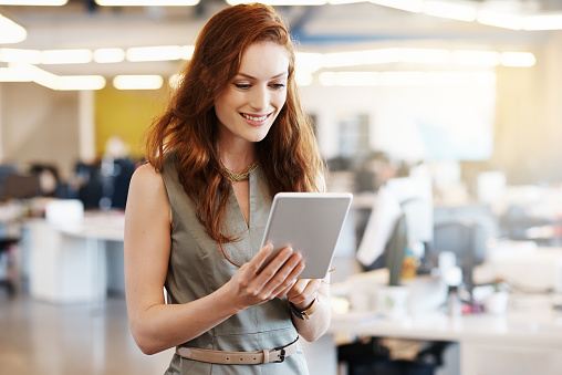 Shot of a successful young businesswoman using a digital tablet at work