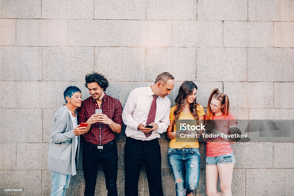 Texting at different ages Five people at different ages texting and sharing with each other. Variation Stock Photo
