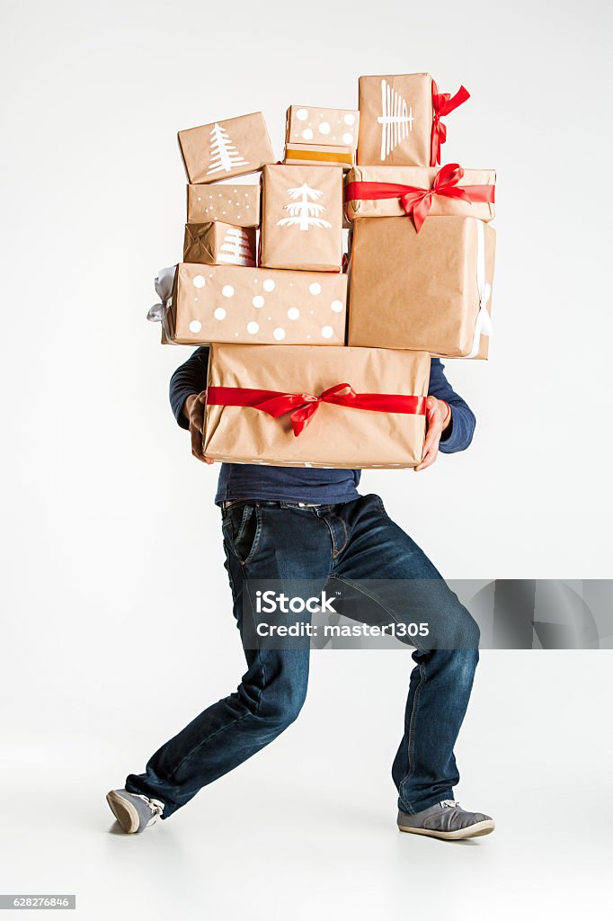 Gift boxes in the hands of young man The lot of gift boxes in the hands of young man on white studio background Gift Stock Photo
