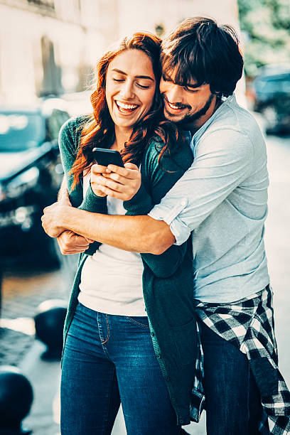 istock Happy couple texting outdoor 628277228