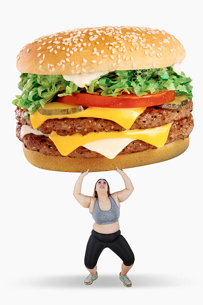 istock Obese woman lifting big hamburger 628280356