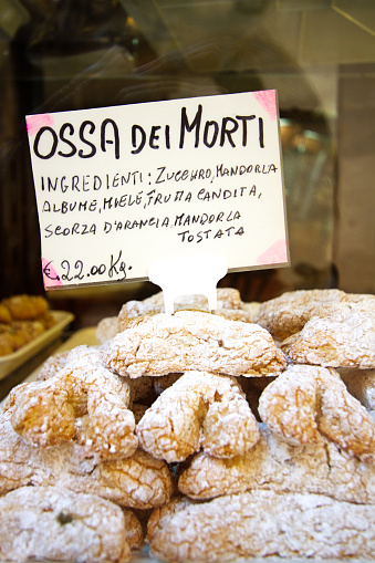 A close-up, luscious-looking pile of Sicilian cookies (Ossa dei Morti/Bones of the Dead) in a bakery shop window. These cookies are especially popular around early November for Day of the Dead.