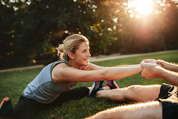 istock Young health couple exercising in park 628295628