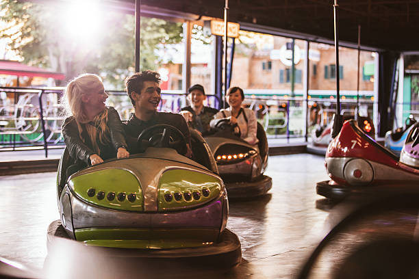 istock Young people driving bumper car at amusement park 628295726