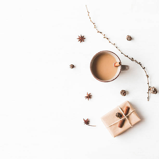 istock Cup of coffee, larch branches, cinnamon sticks,  christmas gift. 628296168