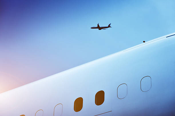 Airplane Flying Through upon the aircraft fuselage, watching the other plane take off. wow airlines stock pictures, royalty-free photos & images