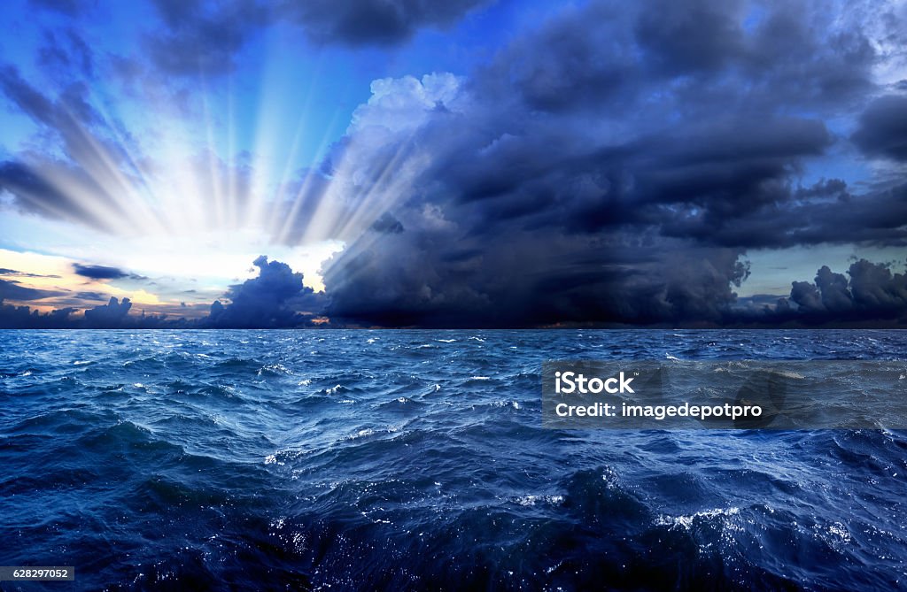 power of nature seascape with waves in stormy day over cloudy sky and sunbeam  Sea Stock Photo