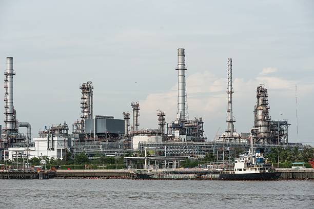 istock Oil refinery near water with blue sky 628298376