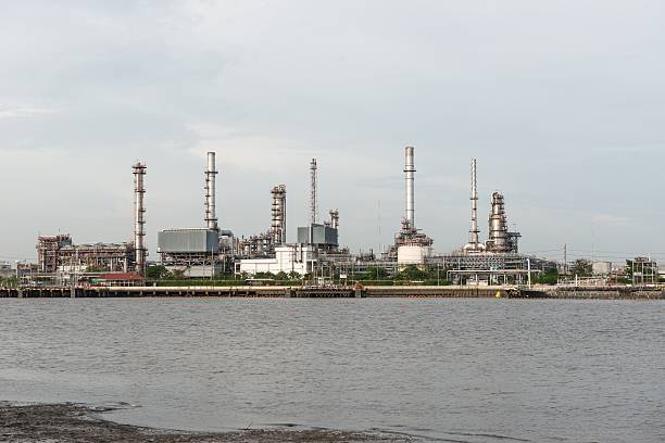 istock Oil refinery near water with blue sky 628298386