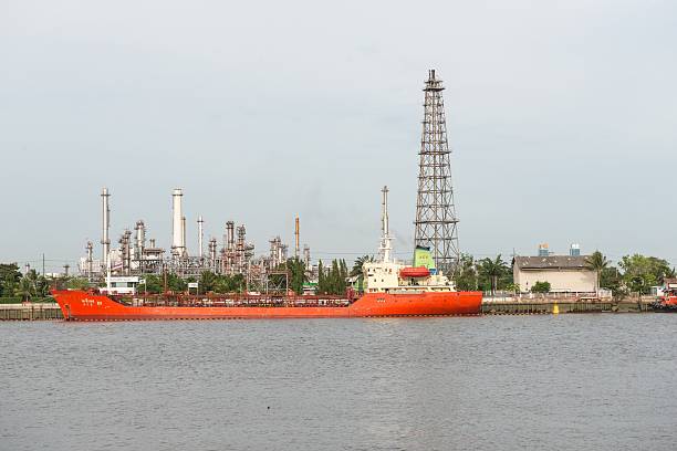 istock Oil refinery near water with blue sky 628298400