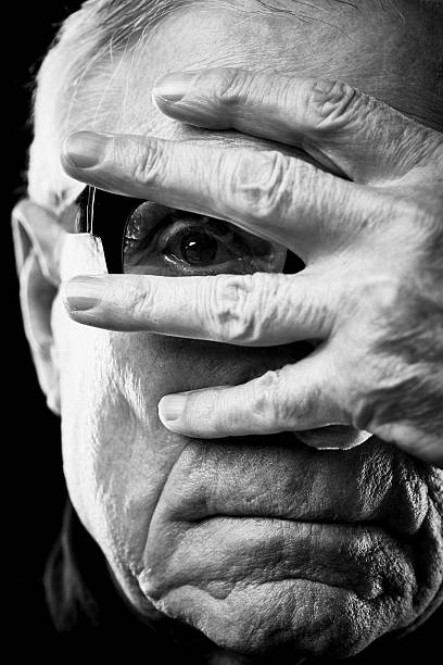 istock Male senior peeking through fingers 628304392