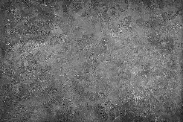 istock Dark grunge textured cement wall closeup 628304492