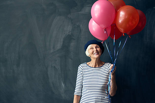 istock Stylish senior woman with balloons 628304618