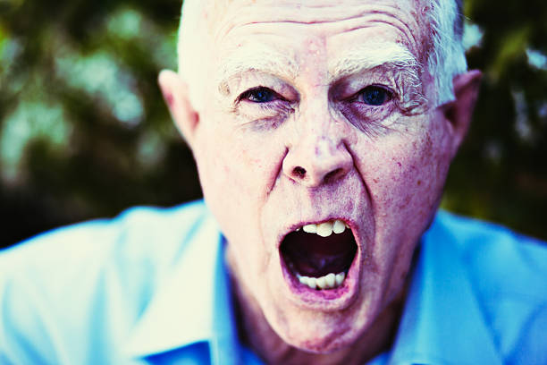 istock Alzheimers or simply angry? Very grumpy old man shouting. 628304694