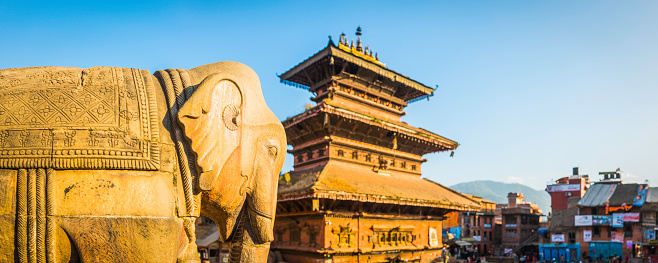 Ancient elephant statue watching over the historic temples and colourful shops of Taumadhi Square in the UNESCO World Heritage Site at Bhaktapur, Kathmandu, Nepal.