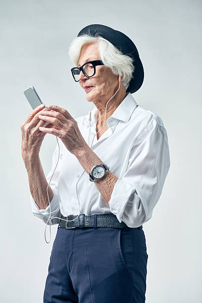 istock Elderly woman wearing headphones 628304840