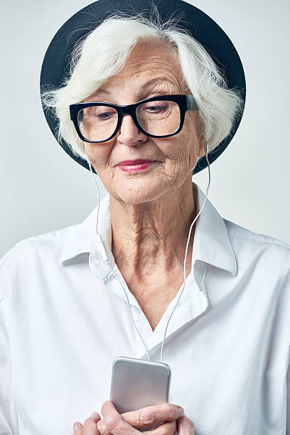 istock Melancholic elderly woman in headphones 628304920